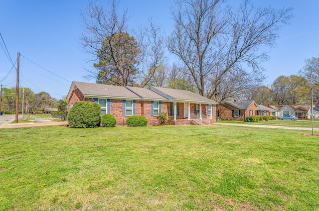 single story home featuring brick siding and a front yard