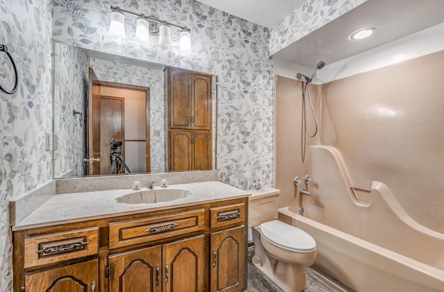 full bathroom featuring a textured ceiling, wallpapered walls, toilet, vanity, and shower / bath combination
