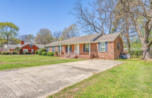 ranch-style home featuring brick siding and a front lawn