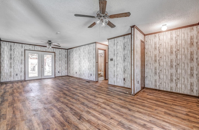 unfurnished living room with ceiling fan, wood finished floors, french doors, and crown molding
