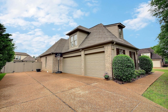 1700 Cypress Springs Ln, Collierville, TN 38017 - view of side of home featuring brick siding, concrete driveway, roof with shingles, and a gate