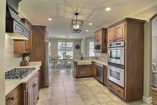 1700 Cypress Springs Ln, Collierville, TN 38017 - kitchen featuring stainless steel appliances, a chandelier, a sink, a peninsula, and ornamental molding
