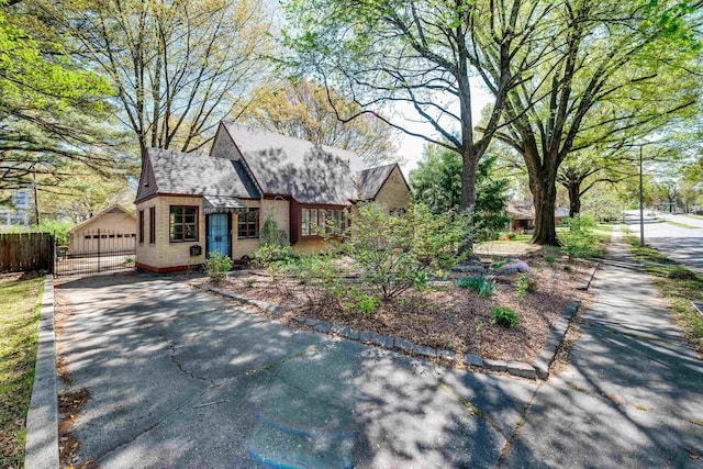 view of front of house with fence and brick siding