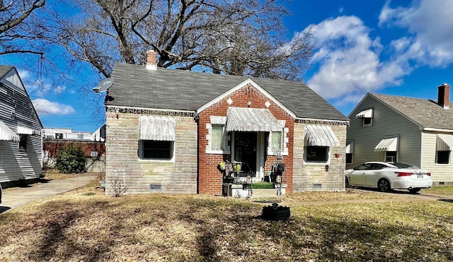 2768 Burns Ave, Memphis, TN 38114 - view of front of house featuring stone siding, crawl space, and a chimney