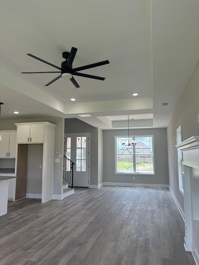 9742 Ryder Springs Dr, Cordova, TN 38018 - unfurnished living room featuring a tray ceiling, dark wood-style floors, baseboards, a chandelier, and recessed lighting