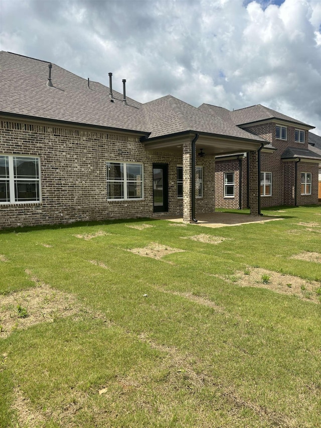 9742 Ryder Springs Dr, Cordova, TN 38018 - rear view of house with brick siding, a shingled roof, a patio, and a lawn