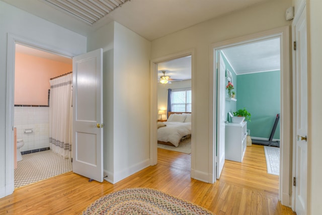 26 N Ashlawn Dr, Memphis, TN 38112 - corridor featuring wainscoting, light wood-style flooring, and tile walls