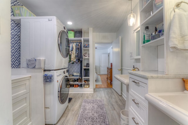 26 N Ashlawn Dr, Memphis, TN 38112 - laundry room featuring stacked washer / drying machine, laundry area, recessed lighting, and light wood finished floors