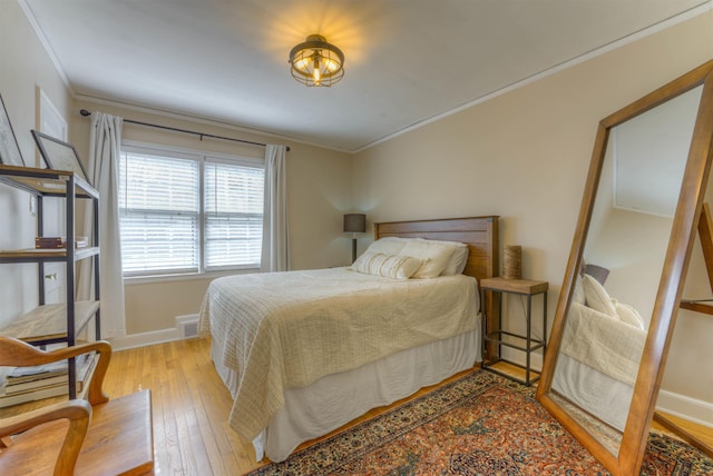 26 N Ashlawn Dr, Memphis, TN 38112 - bedroom featuring baseboards, light wood-type flooring, and crown molding