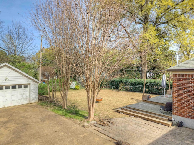 26 N Ashlawn Dr, Memphis, TN 38112 - view of yard featuring an outbuilding, a detached garage, and a wooden deck