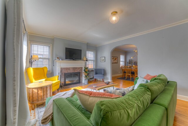 26 N Ashlawn Dr, Memphis, TN 38112 - living room with a fireplace with flush hearth, wood finished floors, baseboards, arched walkways, and ornamental molding