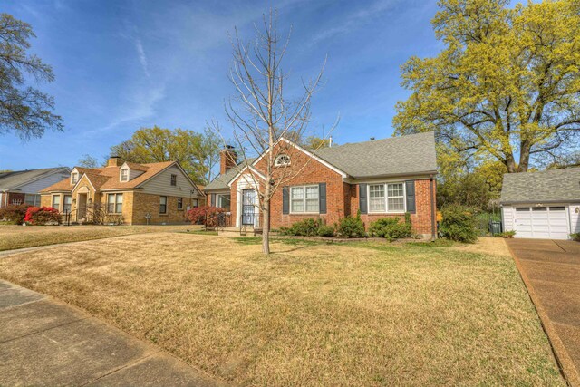 26 N Ashlawn Dr, Memphis, TN 38112 - view of front of home with an outdoor structure, a front yard, brick siding, a garage, and a chimney