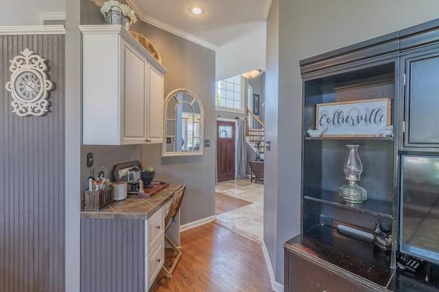 1249 Mintmere Dr, Collierville, TN 38017 - kitchen featuring light wood-style flooring, white cabinets, and crown molding