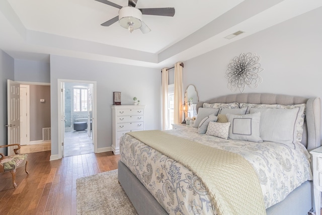 1249 Mintmere Dr, Collierville, TN 38017 - bedroom with wood finished floors, a raised ceiling, ensuite bathroom, and ceiling fan