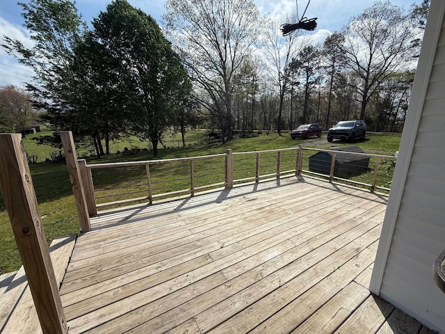 wooden terrace with a lawn