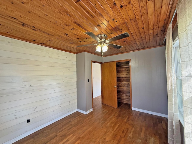 unfurnished bedroom featuring baseboards, a closet, wood finished floors, and wood ceiling