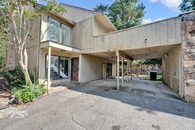 exterior space featuring an attached carport and aphalt driveway