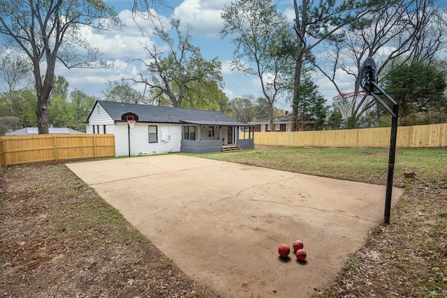 1681 Frayser Blvd N, Memphis, TN 38127 - rear view of house featuring basketball hoop and concrete driveway