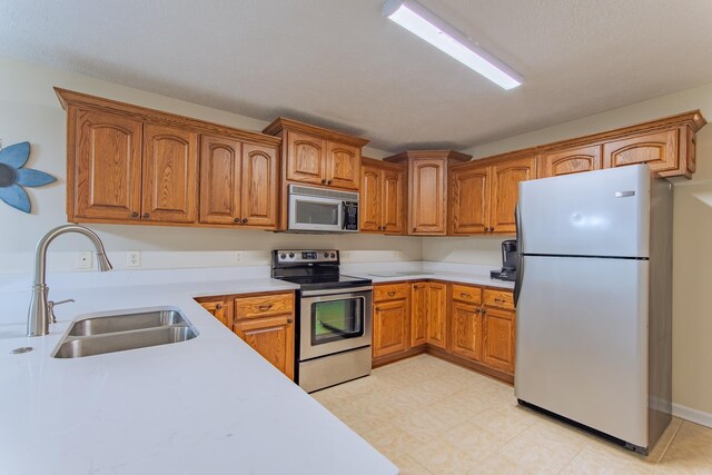 145 Ping Hill Cv, Counce, TN 38326 - kitchen with brown cabinets, light countertops, a sink, and stainless steel appliances