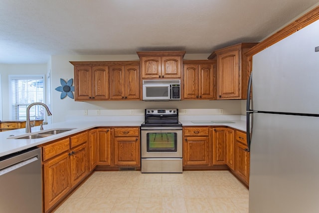145 Ping Hill Cv, Counce, TN 38326 - kitchen featuring a sink, stainless steel appliances, and brown cabinets