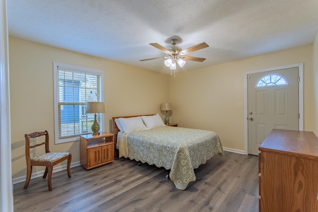 145 Ping Hill Cv, Counce, TN 38326 - bedroom with baseboards, a textured ceiling, wood finished floors, and multiple windows