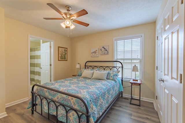 145 Ping Hill Cv, Counce, TN 38326 - bedroom featuring wood finished floors, a textured ceiling, ensuite bath, baseboards, and ceiling fan