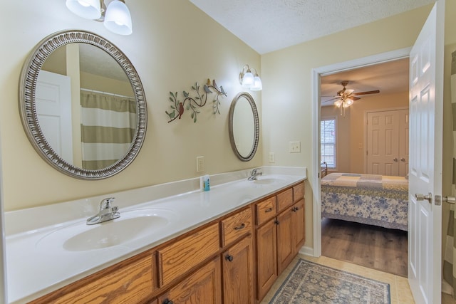 145 Ping Hill Cv, Counce, TN 38326 - ensuite bathroom with double vanity, tile patterned floors, a sink, and a textured ceiling