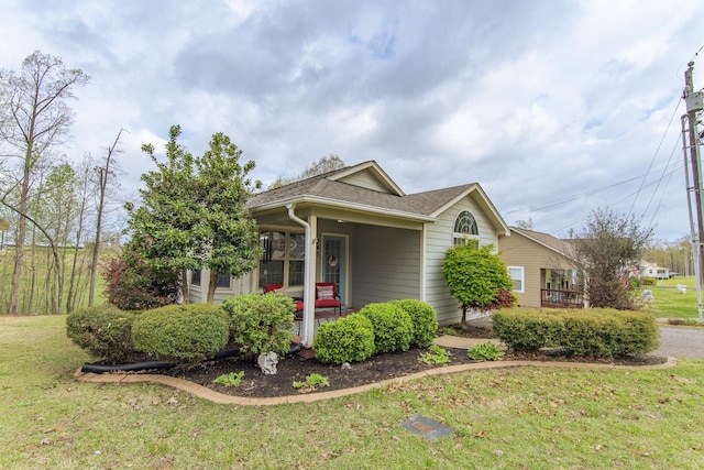145 Ping Hill Cv, Counce, TN 38326 - view of property exterior with covered porch, roof with shingles, and a yard