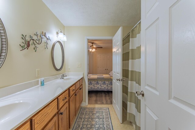 145 Ping Hill Cv, Counce, TN 38326 - full bath with double vanity, a textured ceiling, a sink, and ceiling fan