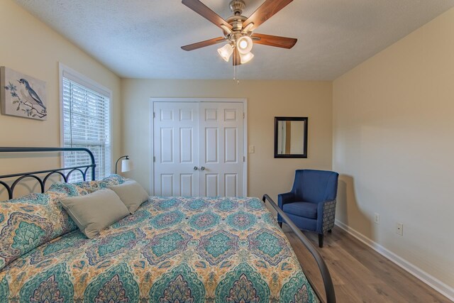 145 Ping Hill Cv, Counce, TN 38326 - bedroom featuring baseboards, a textured ceiling, ceiling fan, a closet, and wood finished floors
