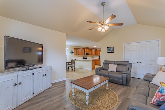 145 Ping Hill Cv, Counce, TN 38326 - living room featuring a ceiling fan, baseboards, lofted ceiling, and light wood finished floors