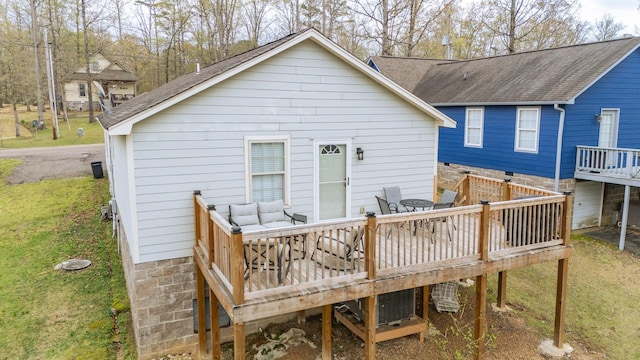 145 Ping Hill Cv, Counce, TN 38326 - back of house featuring a shingled roof, a deck, and a lawn