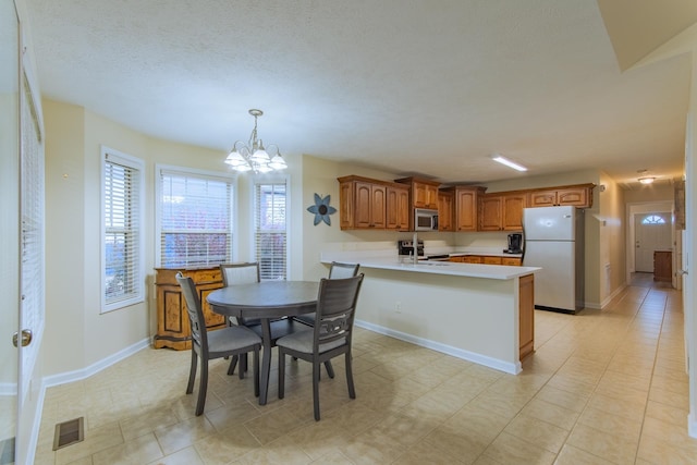 145 Ping Hill Cv, Counce, TN 38326 - dining room with a notable chandelier, a textured ceiling, baseboards, and visible vents