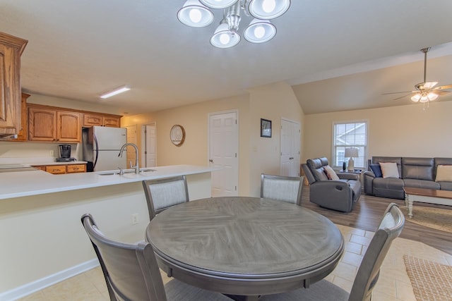 145 Ping Hill Cv, Counce, TN 38326 - dining room featuring light tile patterned flooring, ceiling fan with notable chandelier, and lofted ceiling