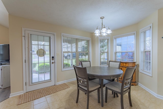 145 Ping Hill Cv, Counce, TN 38326 - dining room featuring baseboards, a textured ceiling, an inviting chandelier, and light tile patterned flooring