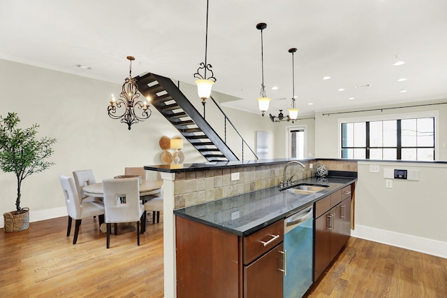 358 N Island Dr Unit 105, Memphis, TN 38103 - kitchen with crown molding, decorative backsplash, a sink, light wood finished floors, and dishwasher