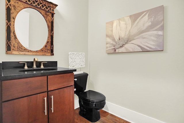 358 N Island Dr Unit 105, Memphis, TN 38103 - bathroom featuring toilet, wood finished floors, baseboards, and vanity