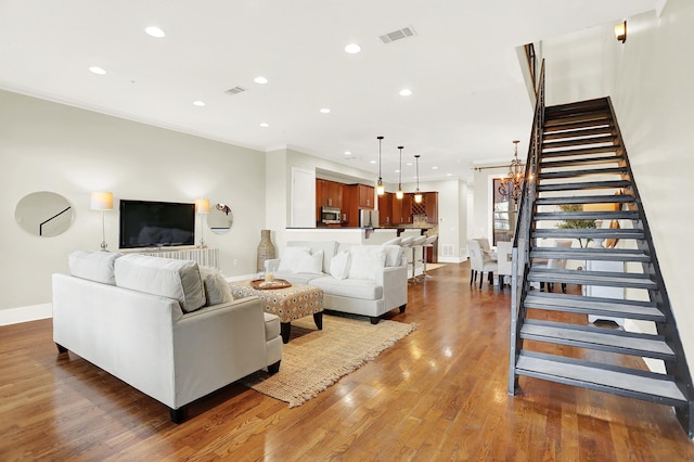 358 N Island Dr Unit 105, Memphis, TN 38103 - living room with crown molding, stairway, wood finished floors, baseboards, and visible vents