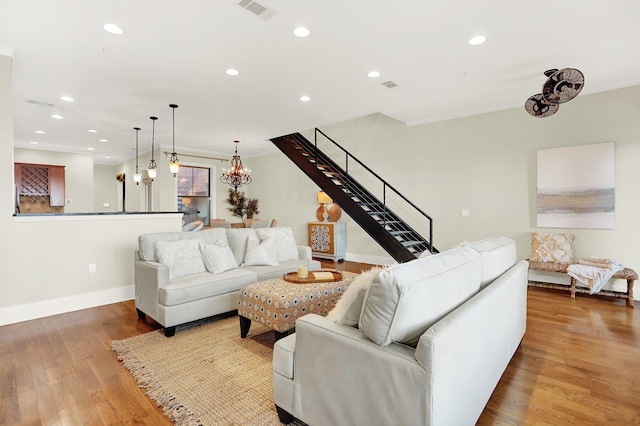 358 N Island Dr Unit 105, Memphis, TN 38103 - living room featuring stairs, wood finished floors, baseboards, visible vents, and recessed lighting