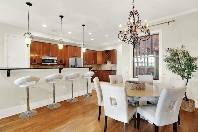 358 N Island Dr Unit 105, Memphis, TN 38103 - dining space with crown molding, a chandelier, light wood finished floors, visible vents, and recessed lighting