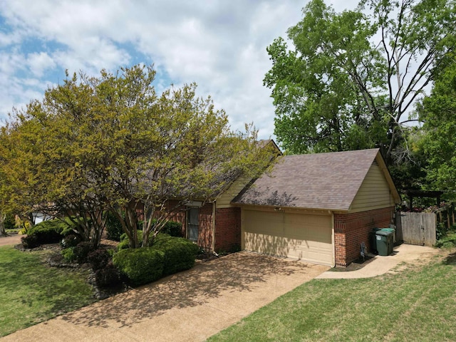 view of front of home featuring an attached garage, brick siding, driveway, and a front lawn