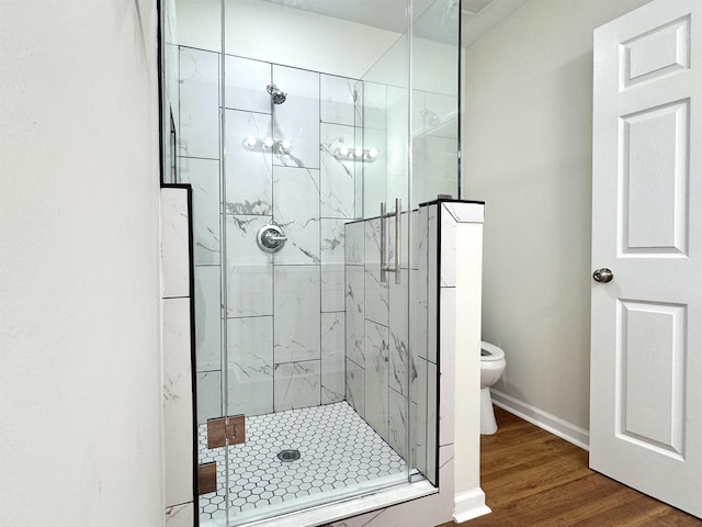1280 Salem St, Memphis, TN 38122 - bathroom with toilet, a stall shower, wood finished floors, and baseboards
