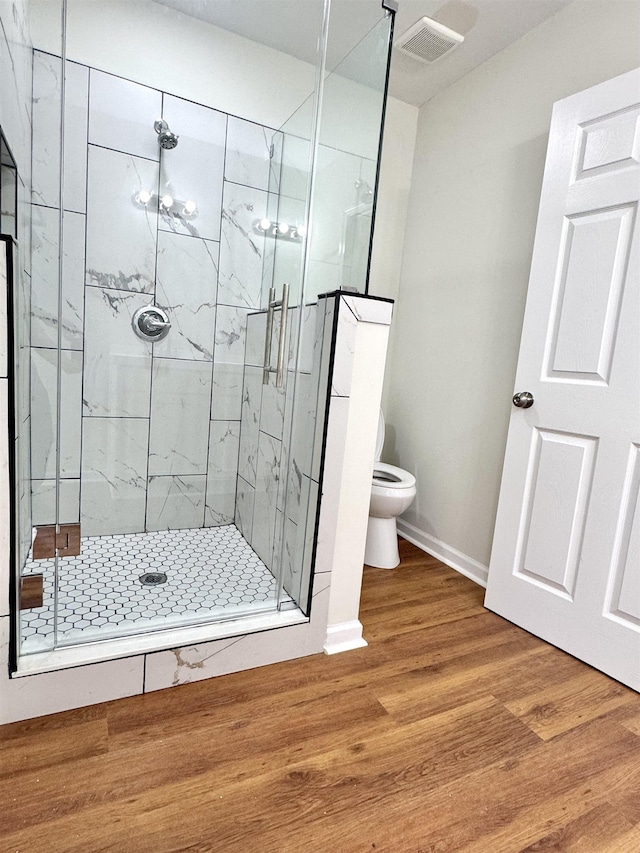 1280 Salem St, Memphis, TN 38122 - bathroom with toilet, visible vents, a stall shower, and wood finished floors