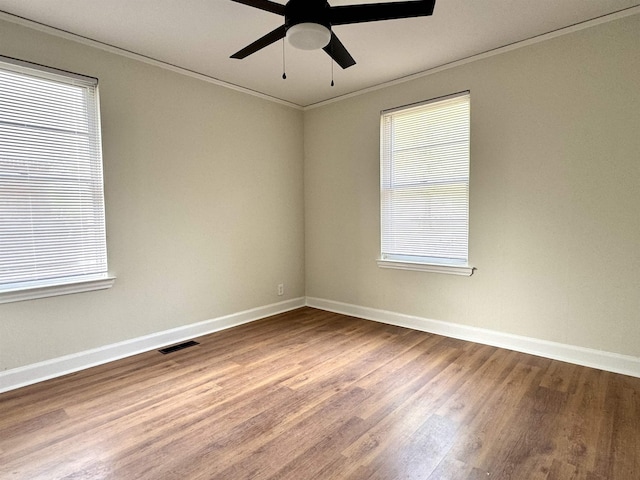 1280 Salem St, Memphis, TN 38122 - empty room featuring visible vents, baseboards, dark wood-style flooring, ornamental molding, and a ceiling fan