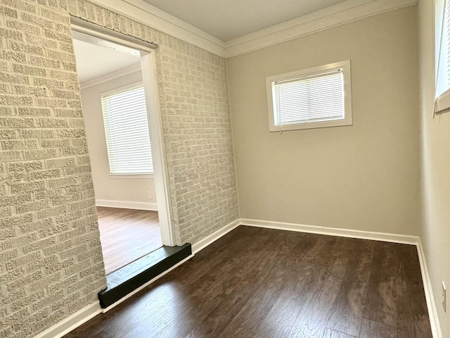 1280 Salem St, Memphis, TN 38122 - unfurnished room featuring dark wood-type flooring, ornamental molding, baseboards, and brick wall