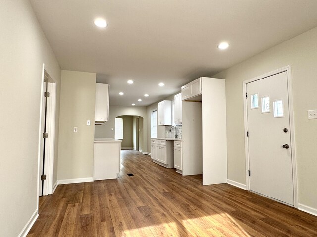 1280 Salem St, Memphis, TN 38122 - kitchen featuring dark wood finished floors, tasteful backsplash, arched walkways, recessed lighting, and light countertops