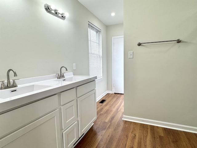 1280 Salem St, Memphis, TN 38122 - bathroom featuring wood finished floors, visible vents, a sink, and baseboards