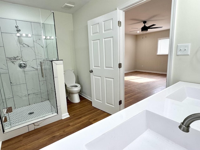 1280 Salem St, Memphis, TN 38122 - full bathroom featuring a ceiling fan, a marble finish shower, toilet, visible vents, and wood finished floors