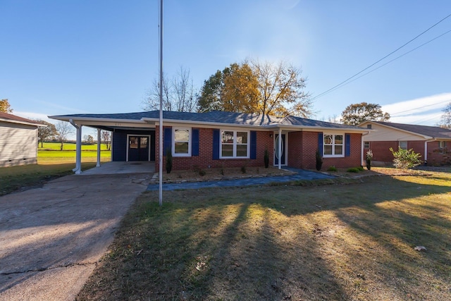 ranch-style home featuring an attached carport, a front yard, brick siding, and driveway