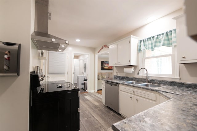 kitchen featuring wall chimney exhaust hood, dishwasher, a sink, white cabinetry, and electric range